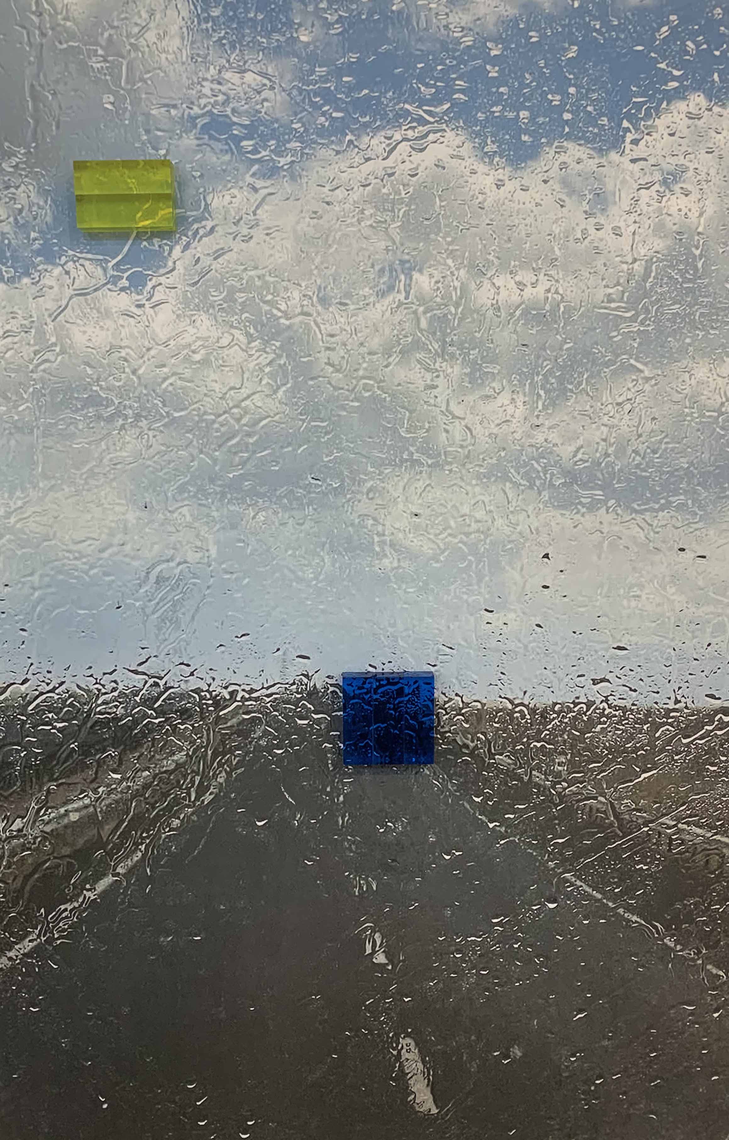 Yildiz Elis Yildirim artwork of a perspective of a highway through a rain-covered windshield, with water droplets obscuring the view and softening details.