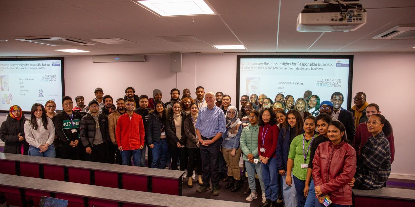 Diverse MBA students and academic staff gathered in a business lecture theatre, highlighting global leadership, professional networking and executive education on the Master of Business Administration (MBA) at the University of Chester.
