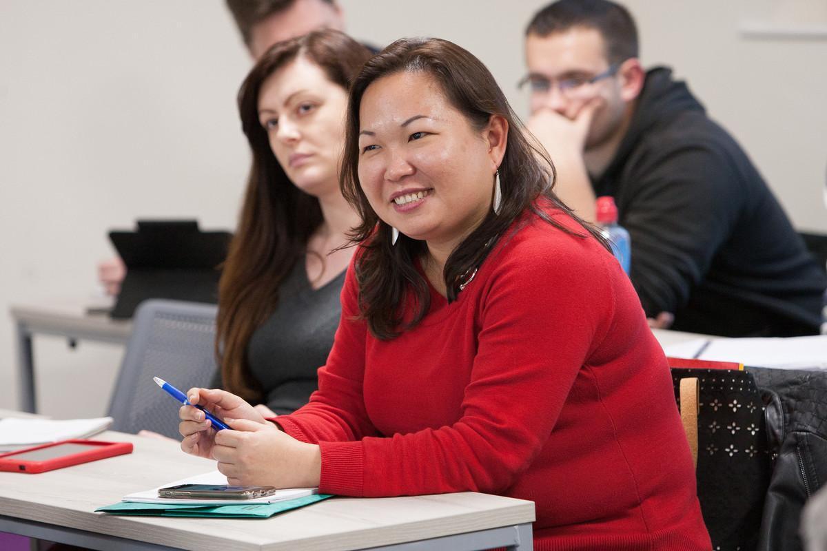 Postgraduate students in a Banking and Finance MSc lecture, engaging in classroom discussion on financial markets, investment analysis, and risk management at university level.