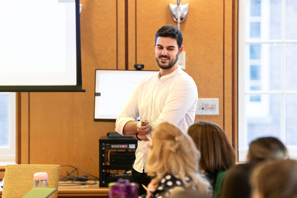 A student standing in front of a group giving presentation