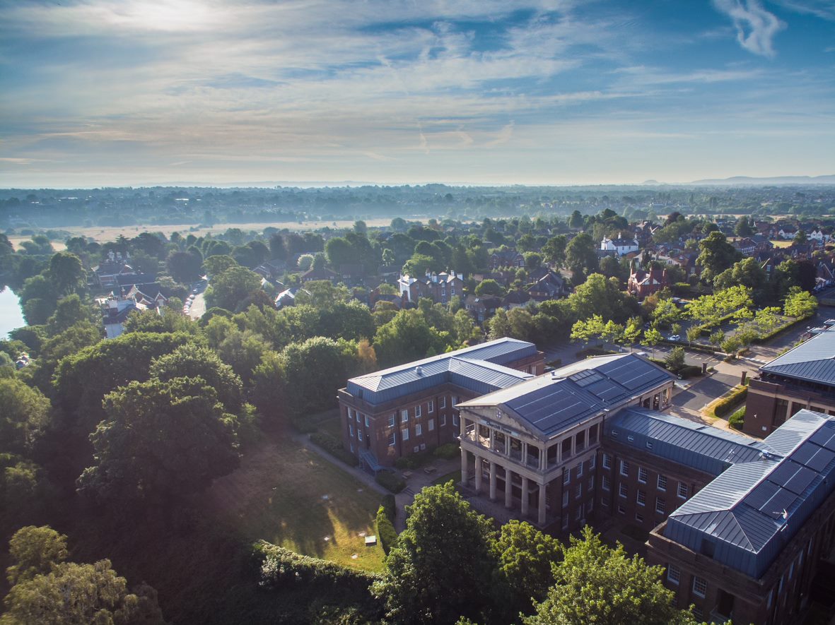 Overhead perspective of a Churchill building showcasing trees and multiple academic buildings in a lush environment.