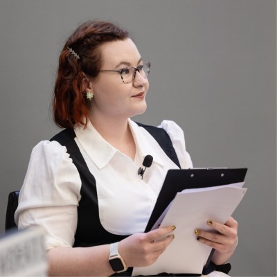 Female professional smiling and holding a notepad