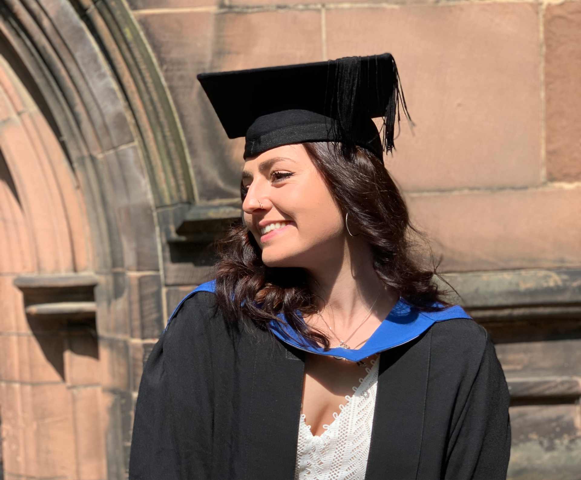 A student wearing a cap and gown at MSc graduation