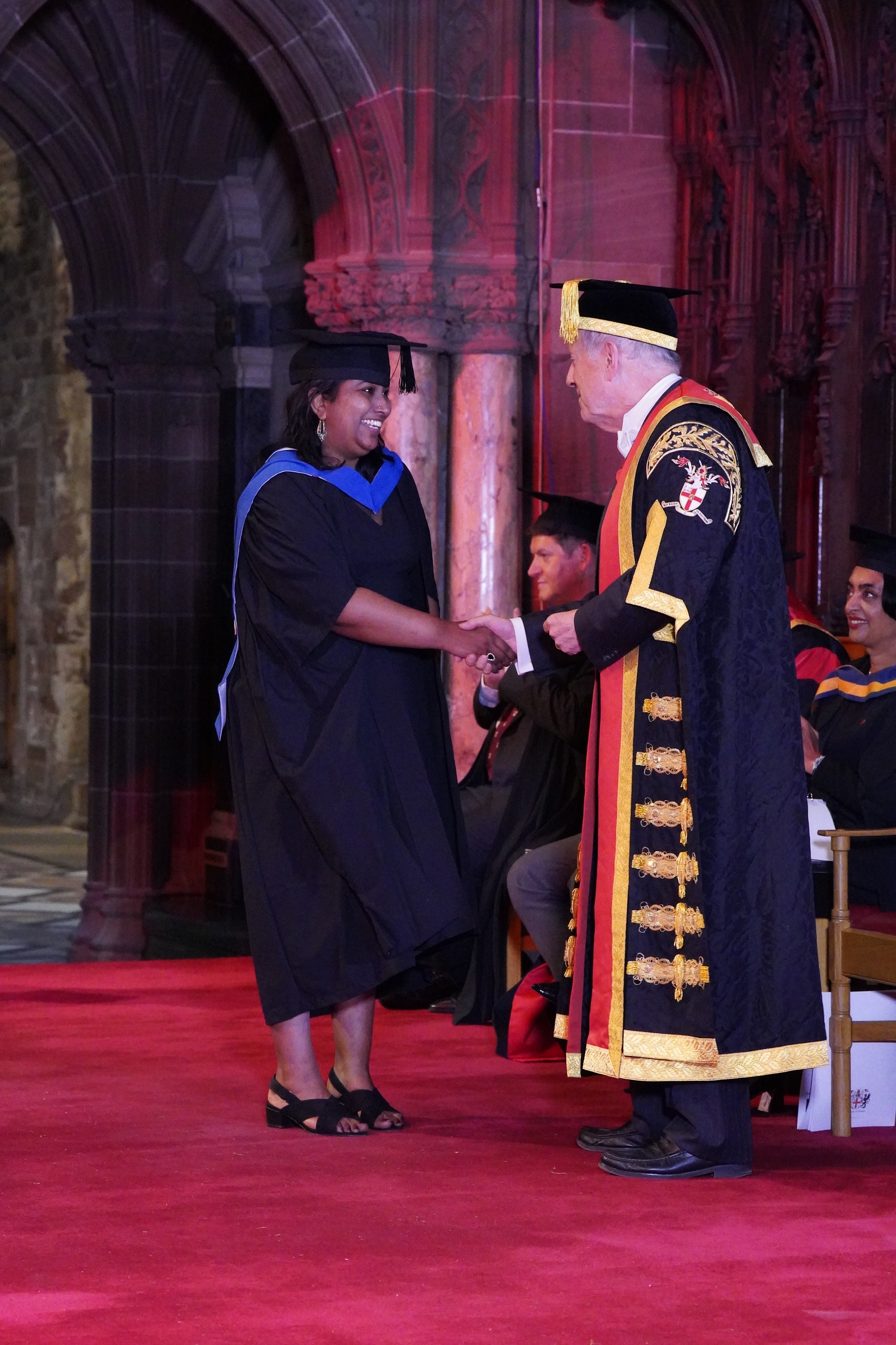 Meenu shaking hands with Gyles Brandreth