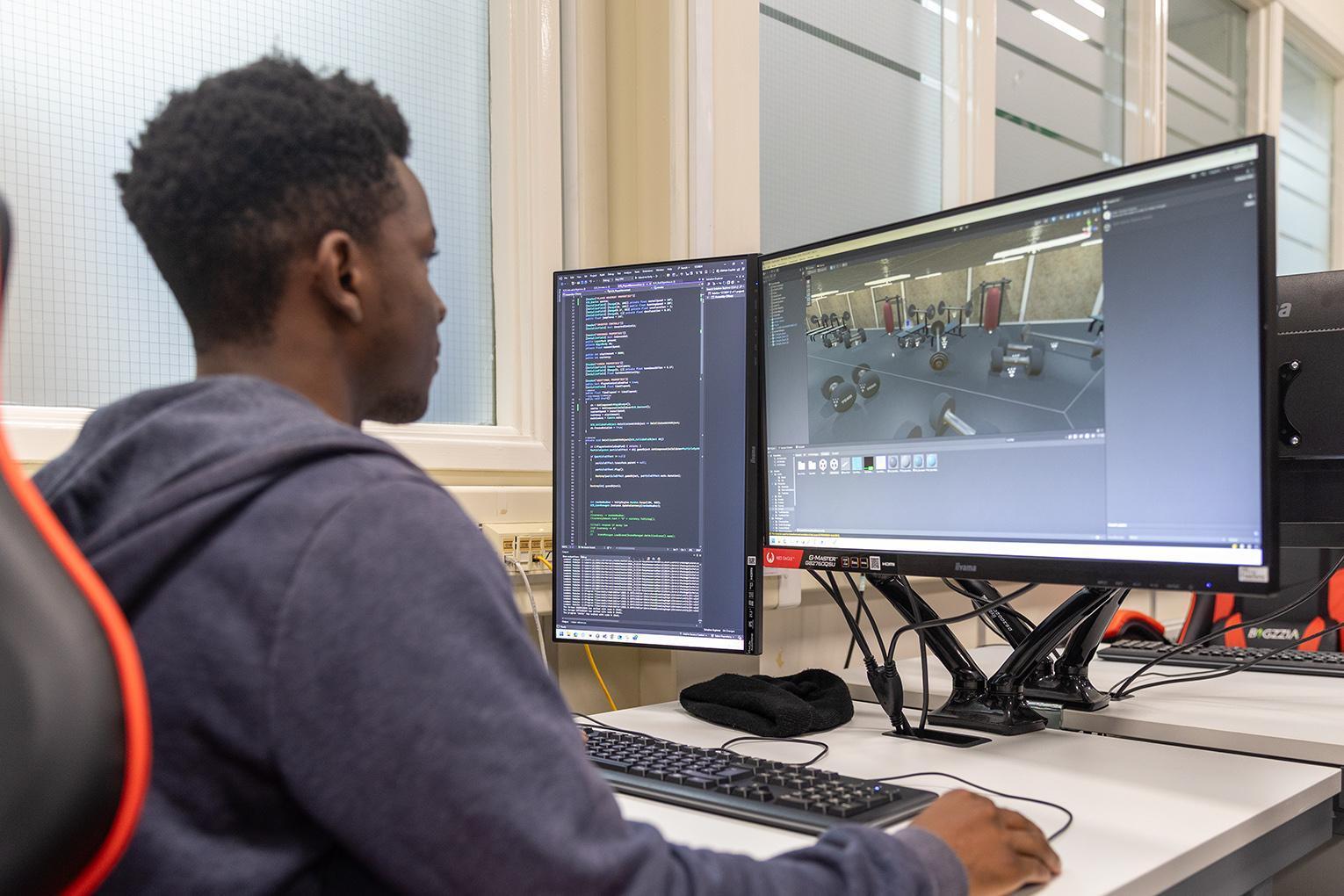 Games Development BSc (Hons) Student coding and designing a 3D game scene as part of their course.