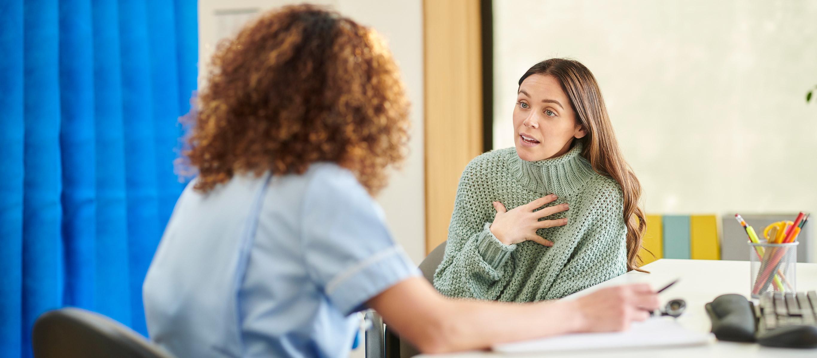 Student practicing counselling skills during a counselling and psychology degree session, talking with a professional therapist in a university setting.