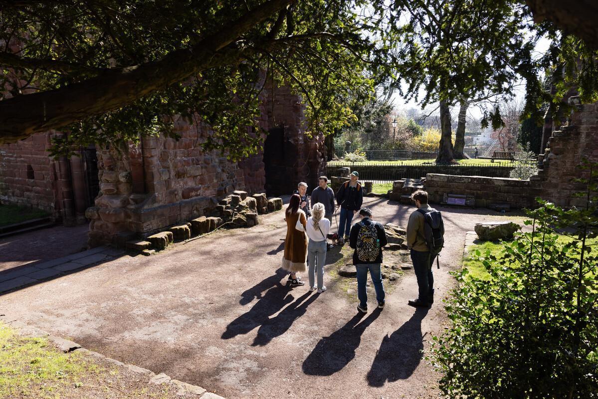 History students on a field trip exploring historic ruins, gaining hands-on learning experience outside the classroom.