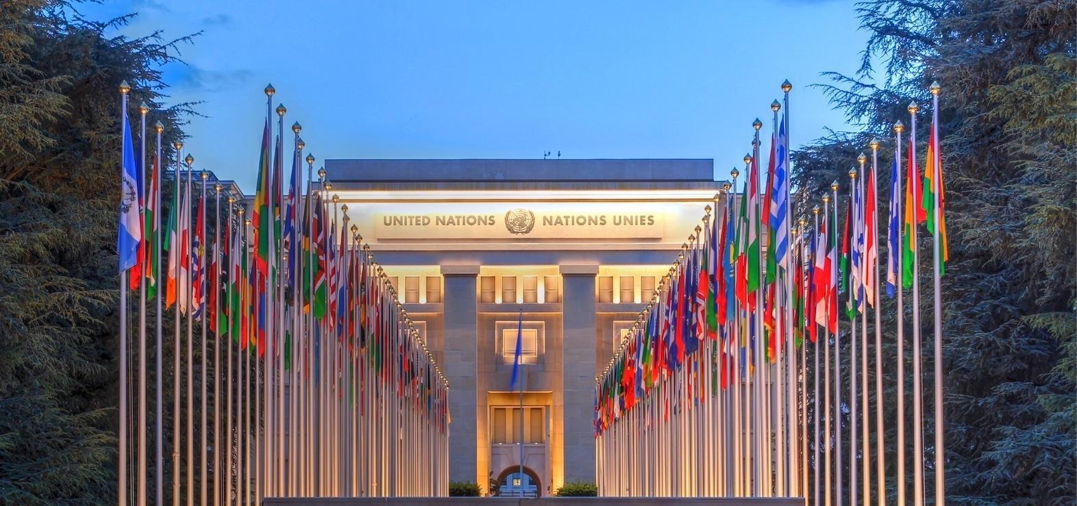 Rows of world flags leading to the United Nations headquarters, reflecting the international cooperation and global perspective central to studying Global Affairs, Politics and International Relations BA hons degree.