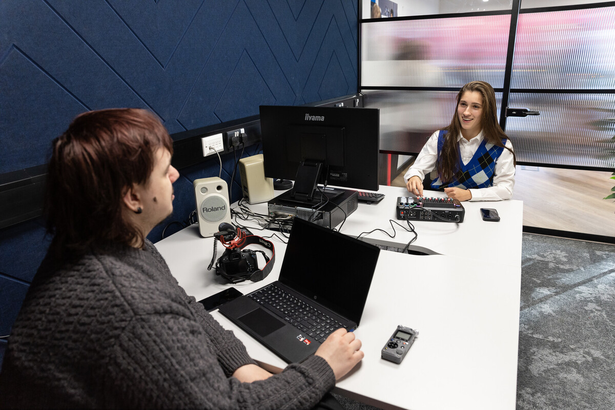 Students in a podcast studio