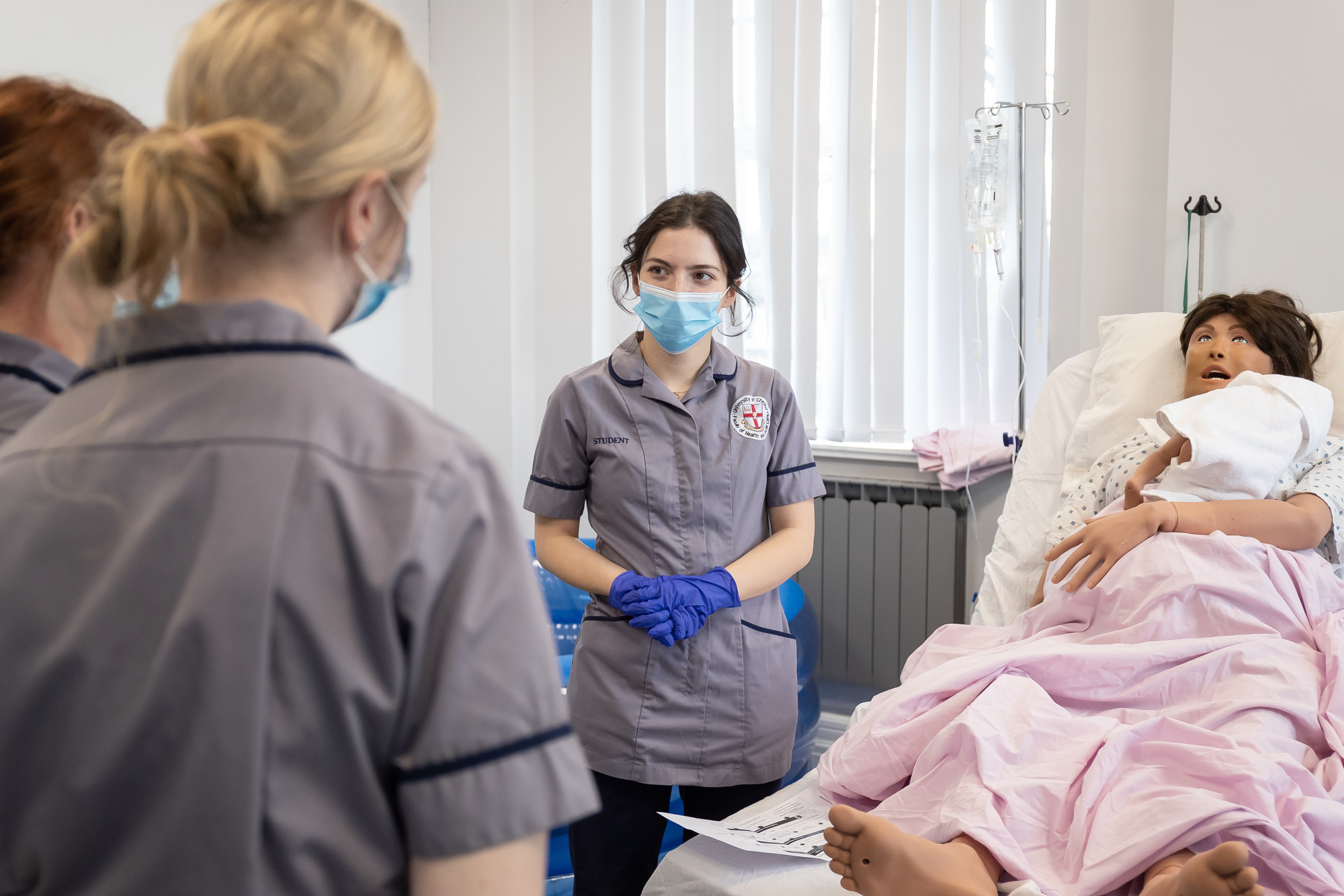 Student nurses in a simulation room