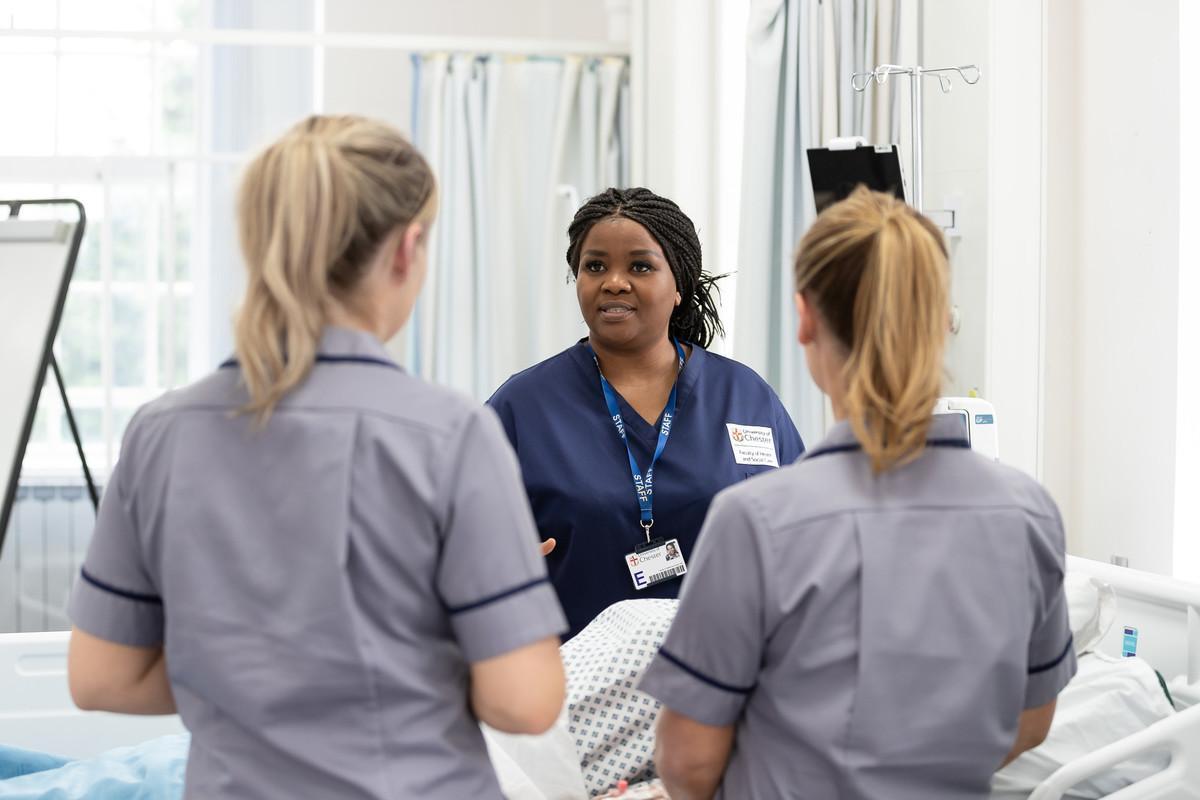 Nursing students practising clinical skills in a healthcare simulation ward, supporting Return to Practice Nursing training at the University of Chester.