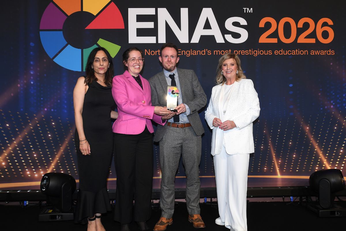 Four people including presenter Lucy Meacock standing and smiling at the camera. Two from the University are holding an award. The background has the ENAs 2026 logo.
