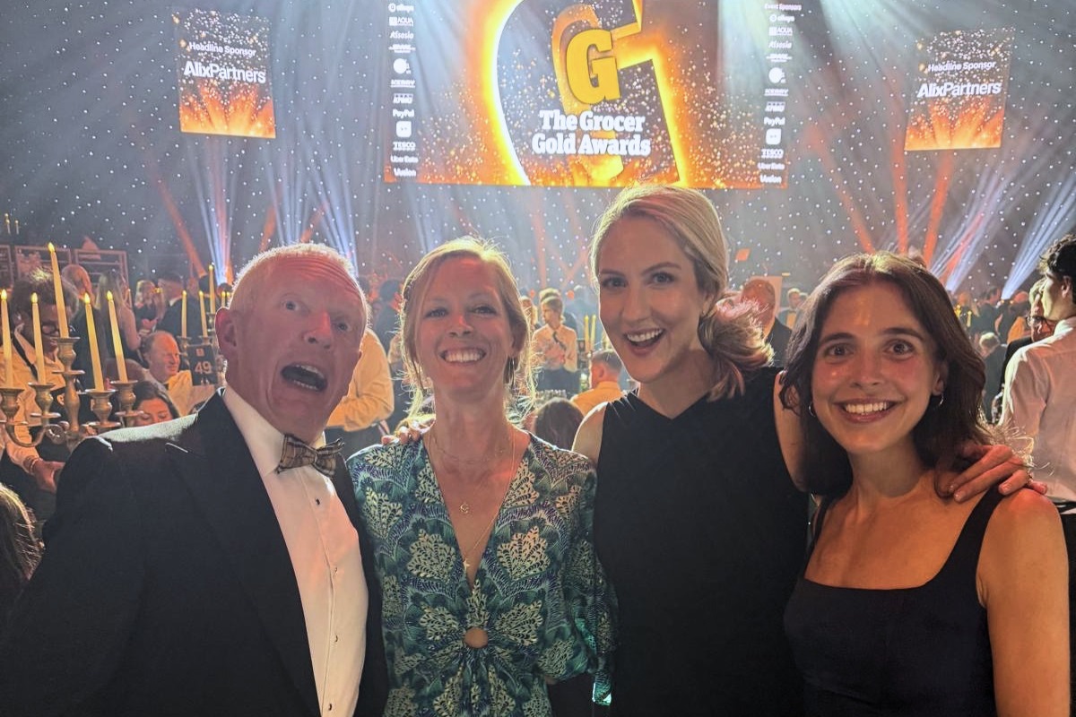 A group of four people in smart clothes smiling at the camera at the Grocer Gold Awards.