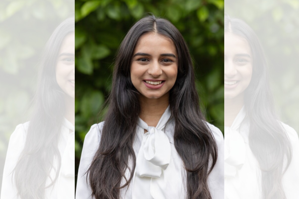 A portrait photo of a woman with long hair smiling at the camera.
