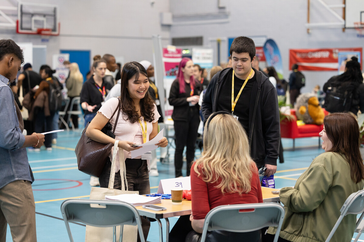 A busy hall filled with people looking at stalls and stands at the Part-time Jobs Fair.
