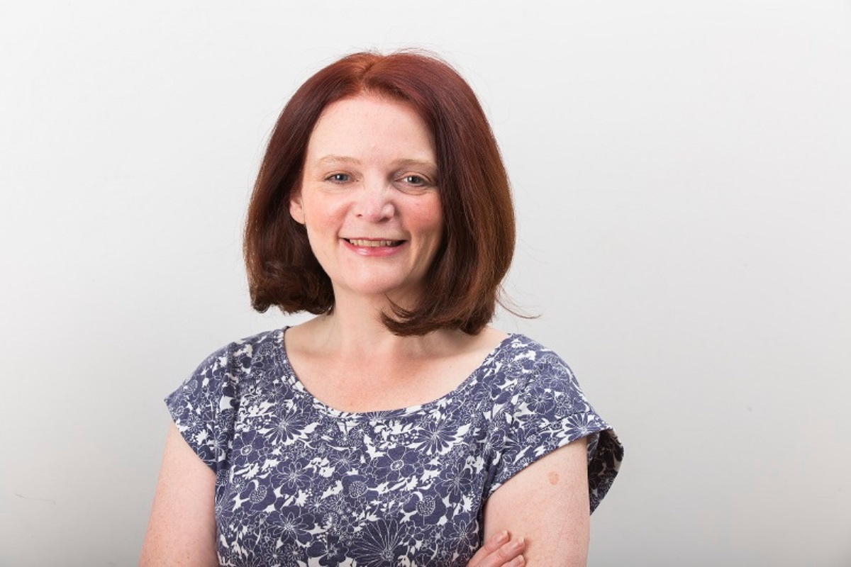 A head and shoulders photo of Ruth Sutton looking at the camera, smiling.