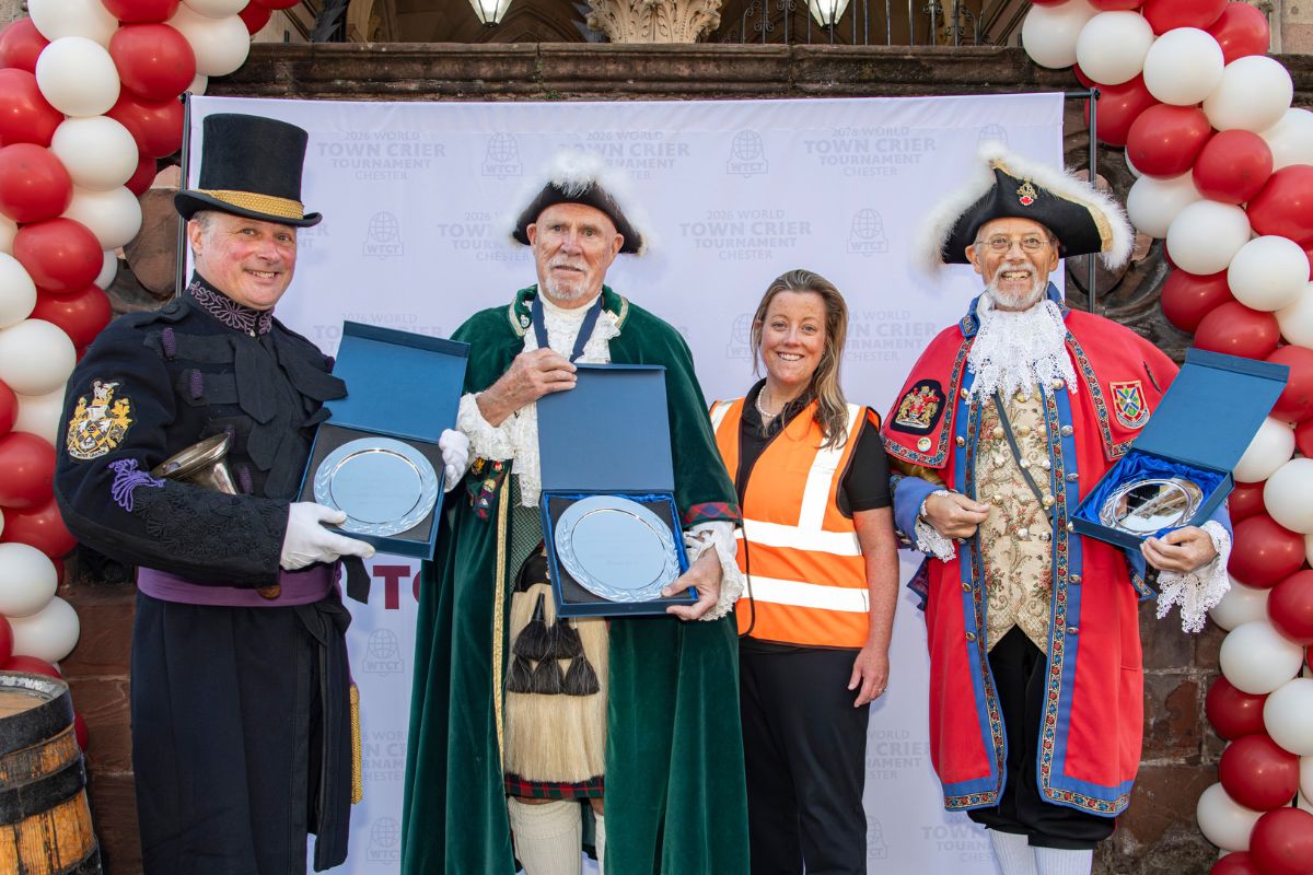 The three winners of Day One’s Hometown Cry competition celebrate their success at the World Town Crier Tournament in Chester, congratulated by Lead Organiser, Ashley Shacklady. Photo by Bob Hadfield.