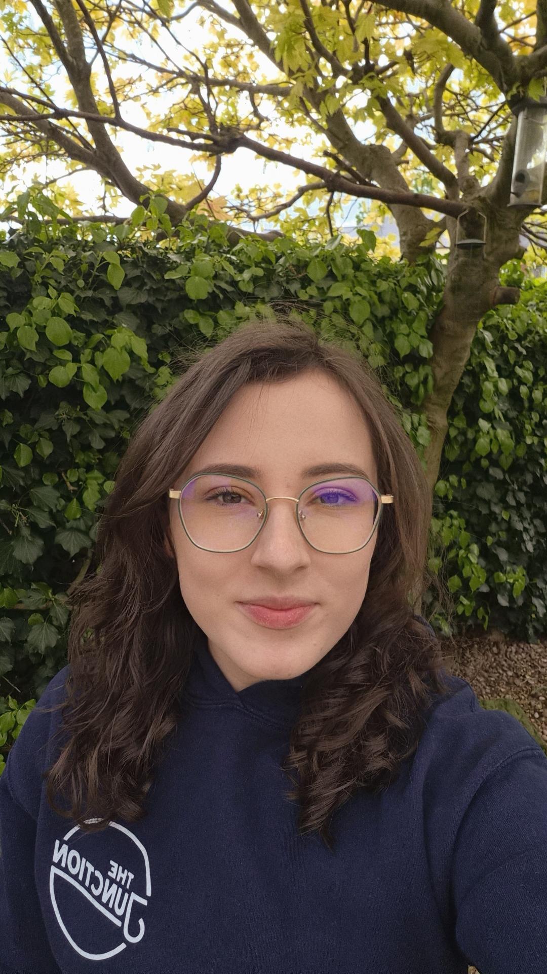 Rebecca- Geography student outside in front of greenery