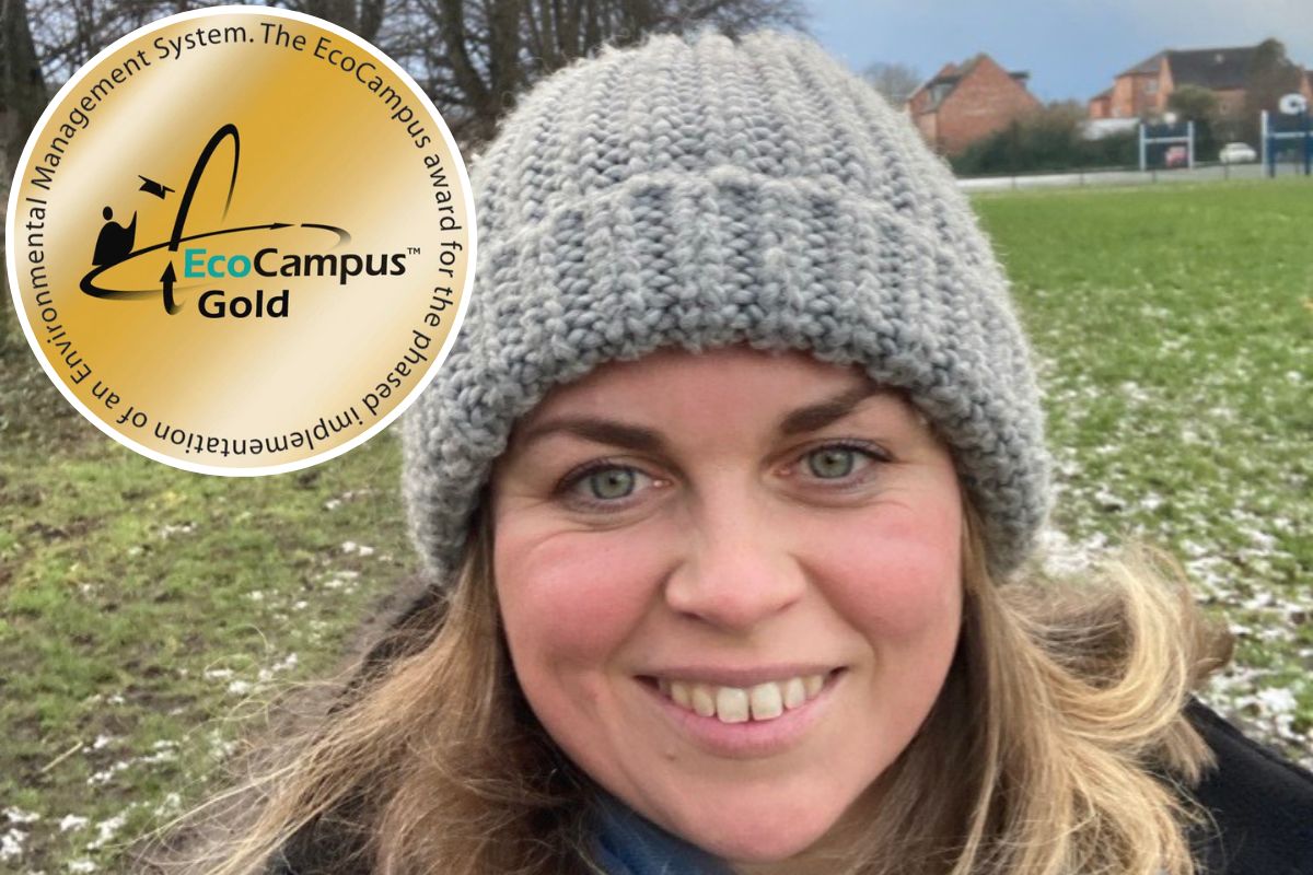 A woman smiling at the camera, wearing a winter hat.