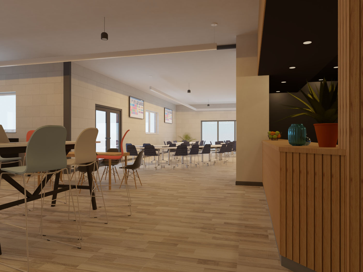 Bright modern café-style space with wooden flooring, colourful chairs, long tables, and a counter with plants and fruit.