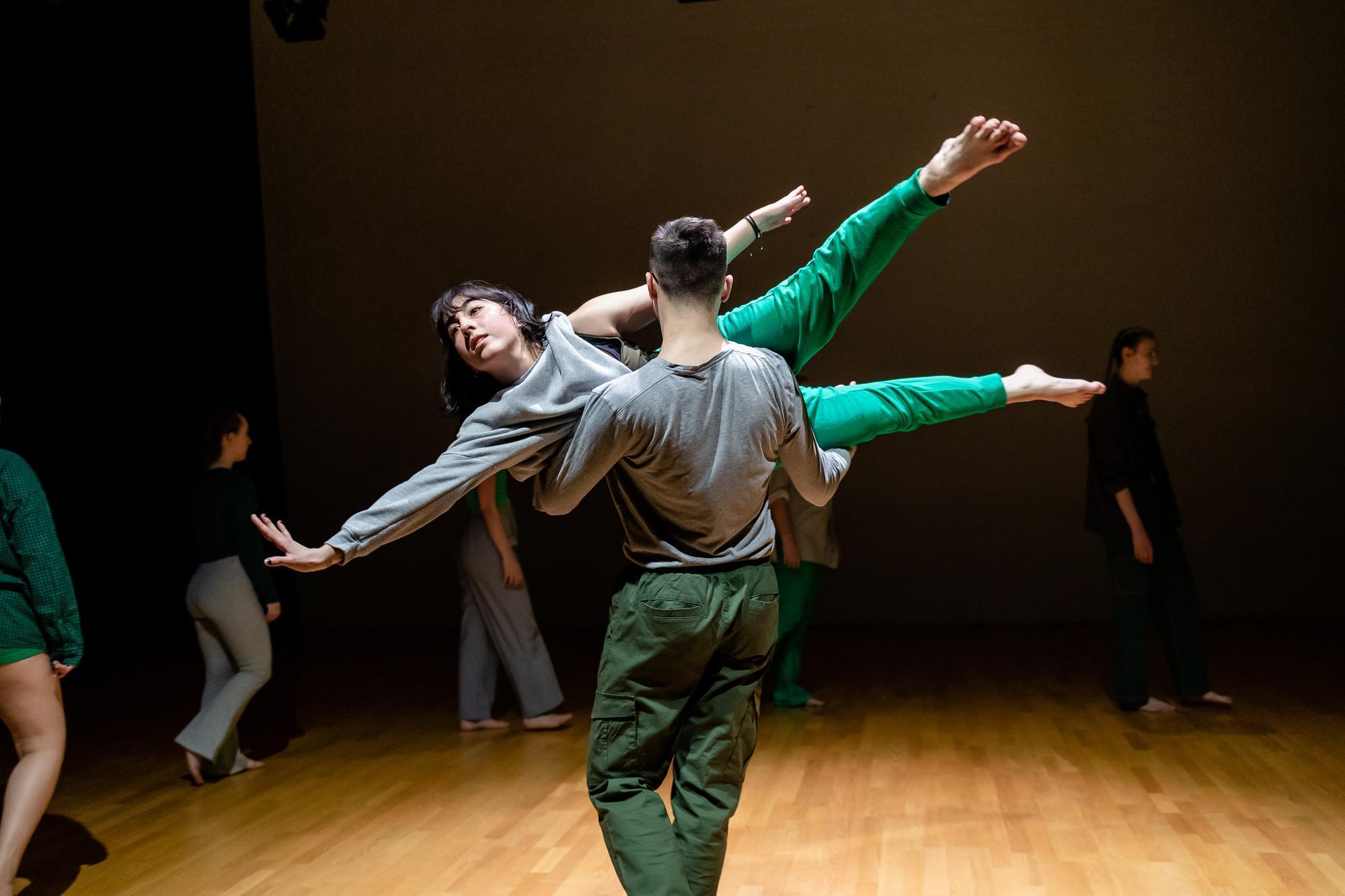 Students from a BA Hons Dance course perform a contemporary routine on stage, showcasing the strength, precision, and artistry developed through a professional degree in dance.