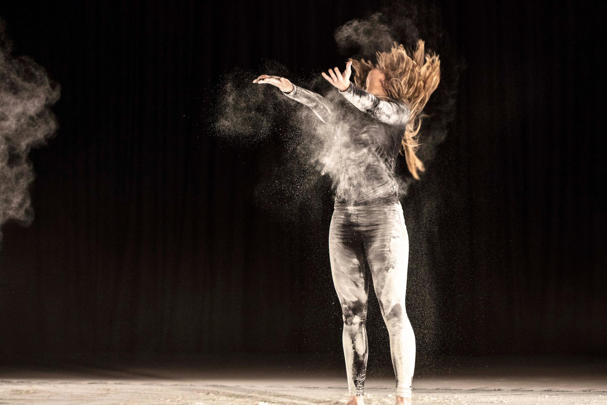 Postgraduate Dance MA student demonstrating contemporary dance techniques and creative choreography during a live stage performance.