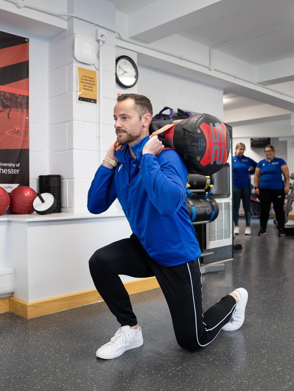 Exercise Medicine MSc student performing functional strength training in a specialist sports science laboratory, developing expertise in exercise prescription, rehabilitation and health performance.