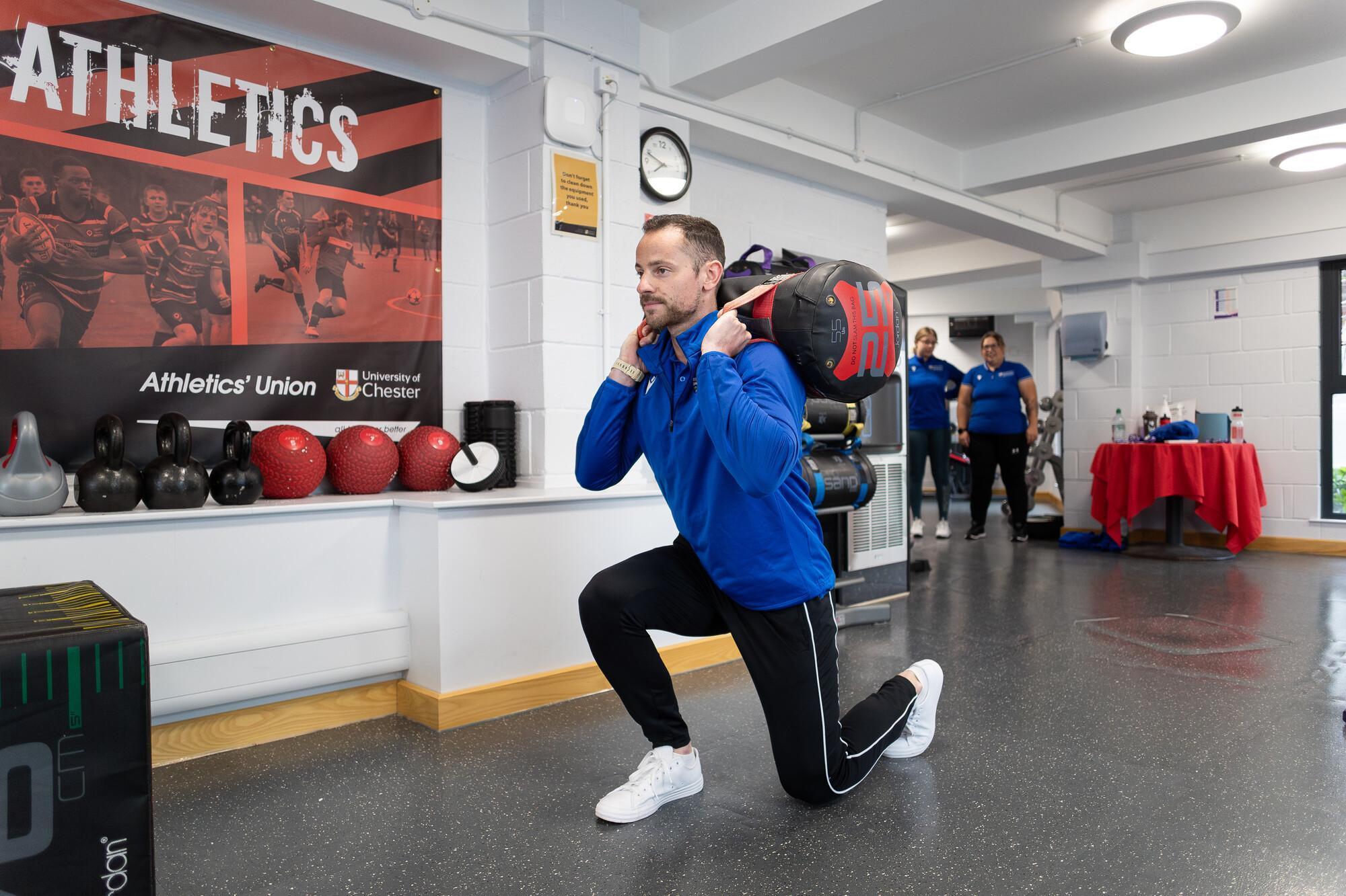 Exercise Medicine MSc student performing functional strength training in a specialist sports science laboratory, developing expertise in exercise prescription, rehabilitation and health performance.