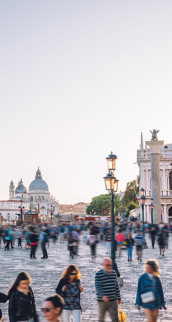 Tourists and students in St. Mark’s Square, Venice, representing global travel, cultural exchange, and international career opportunities offered through a university International Tourism Management BA (Hons) degree program.