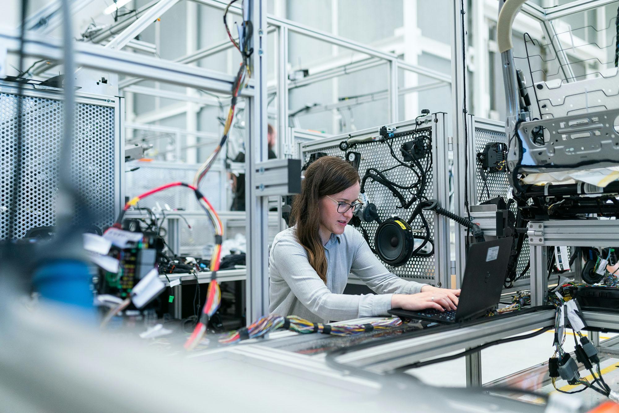 Student working with automated engineering equipment in a laboratory, representing the Mechanical Engineering and Mechatronics MSc at the University of Chester.