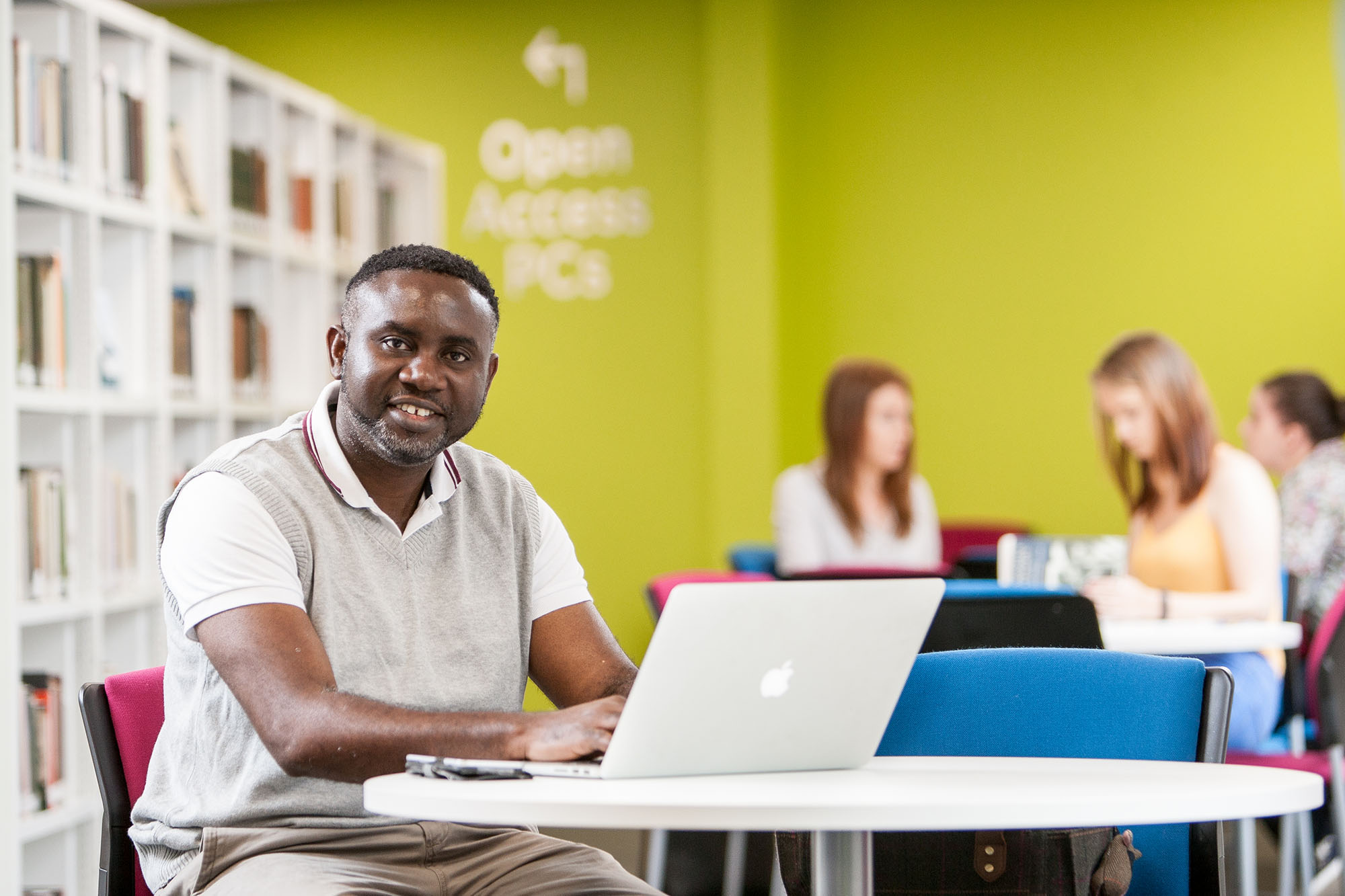 Smiling mature student sitting at desk