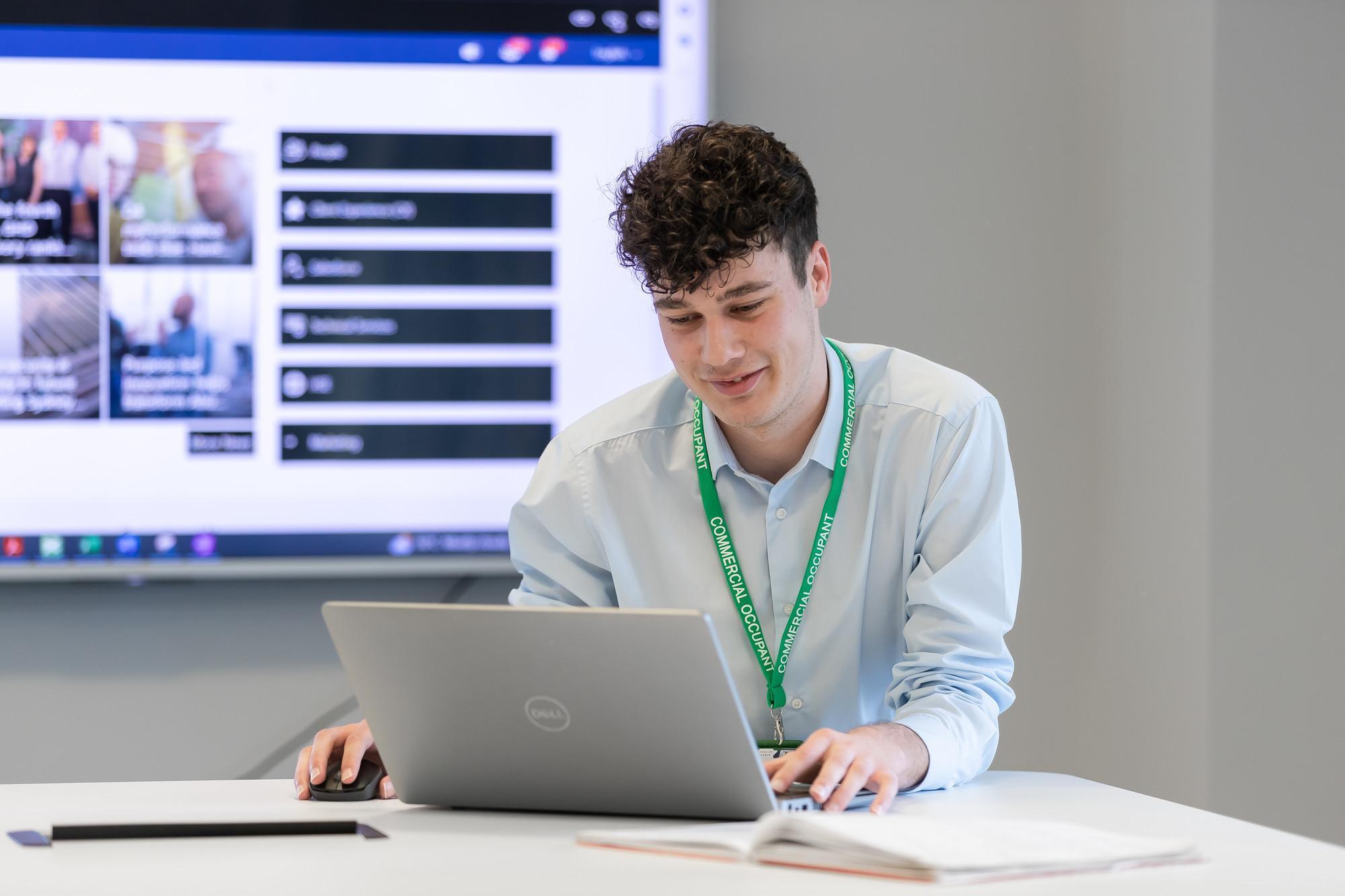 Professional Development by Negotiated Studies BA/BSc (Hons) student using a laptop in a modern learning environment, demonstrating flexible workplace learning and career development at the University of Chester.